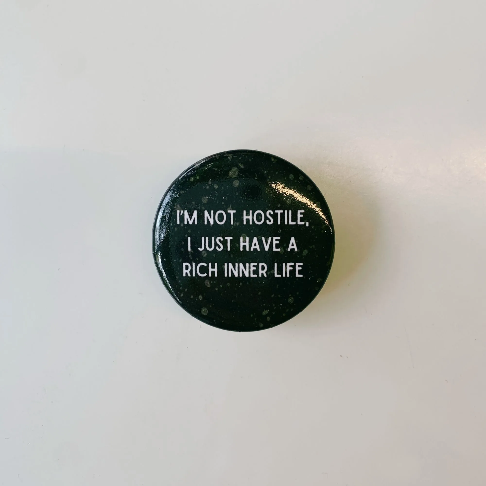 I'm Not Hostile I Just Have a Rich Inner Life 1.5" Button in Black and Tan